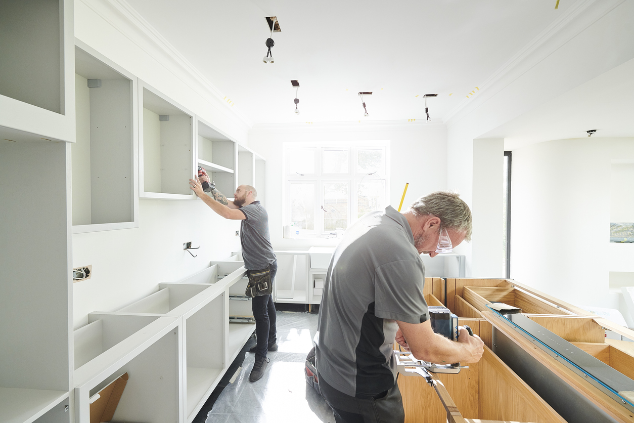 Countertop measuring in kitchen Men measuring kitchen for countertops