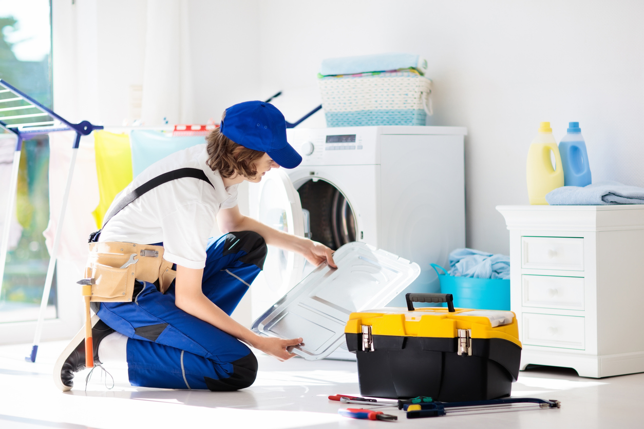 man fixing dryer with tools