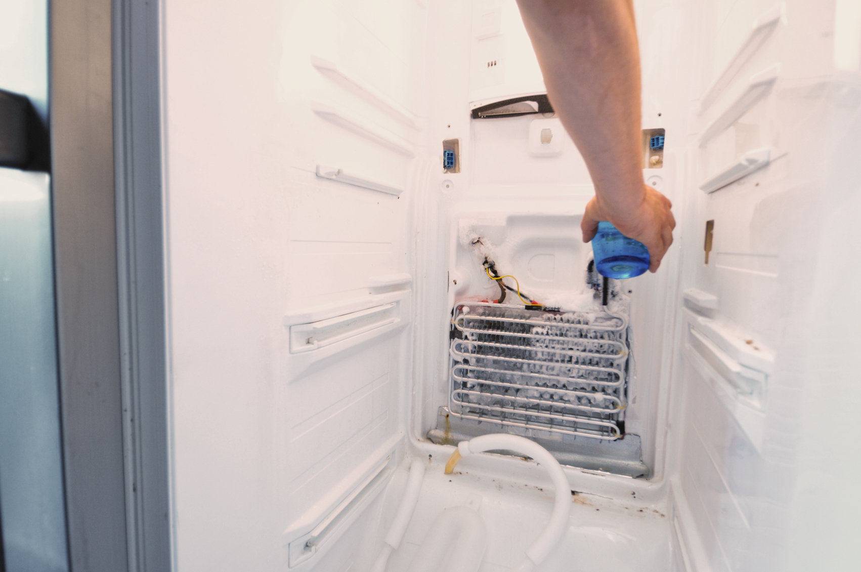 looking at coils in fridge