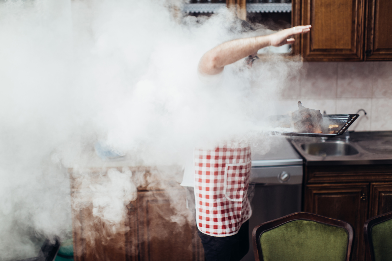 Man in the middle of an oven fire