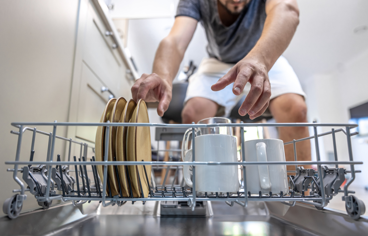 Man unloading dishwasher