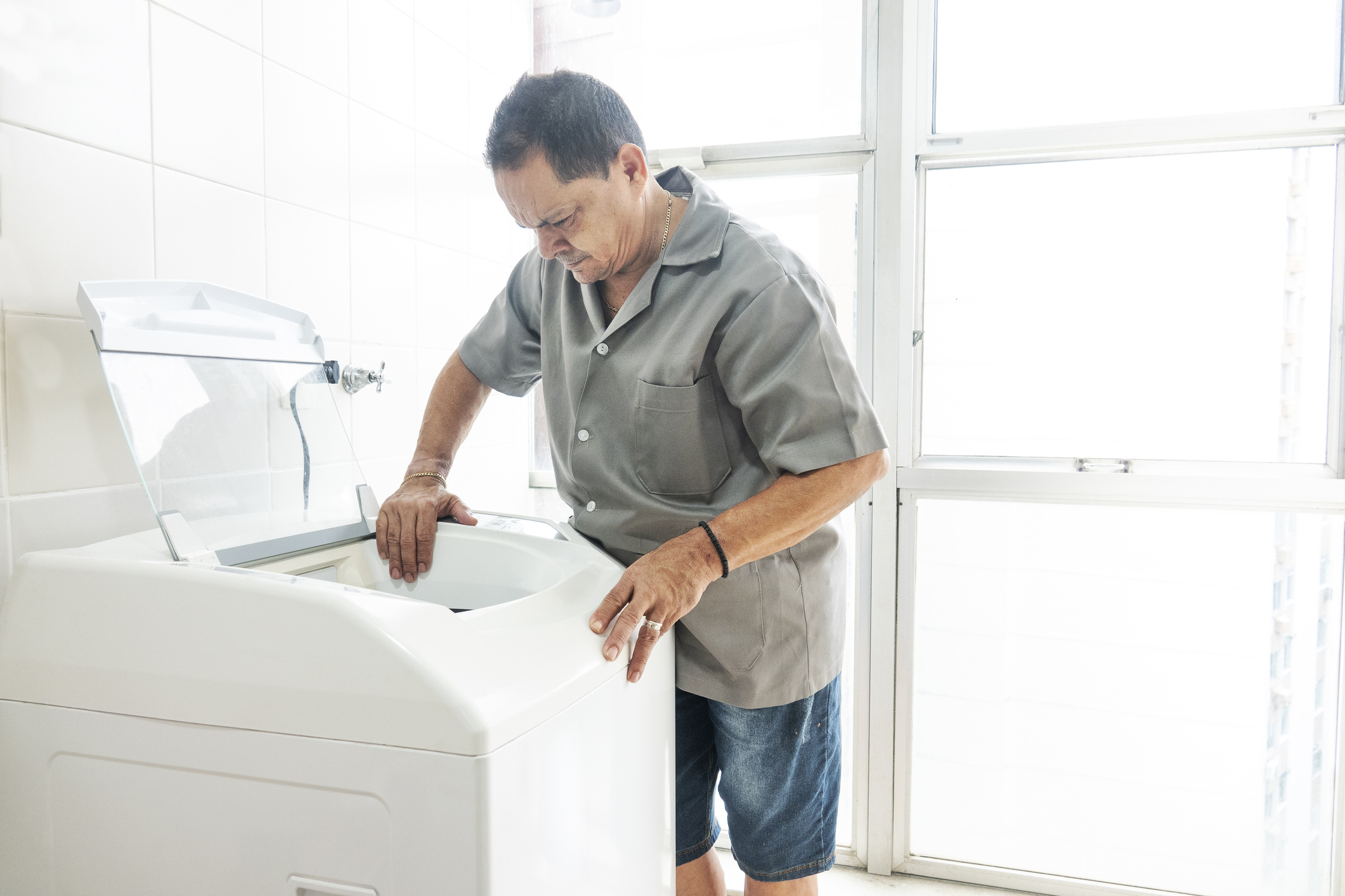 man analyzing top load washer