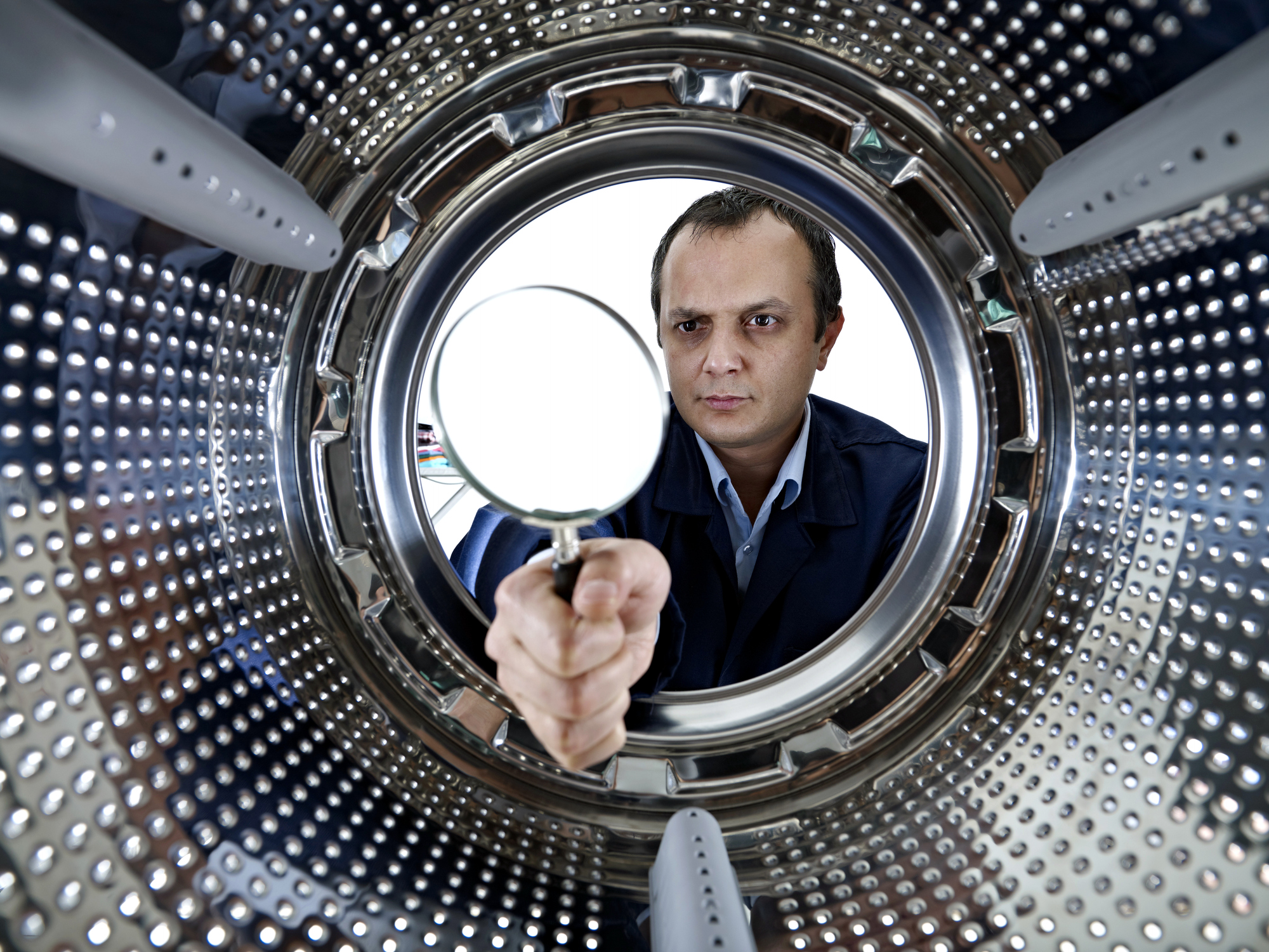 man inspecting washer drum