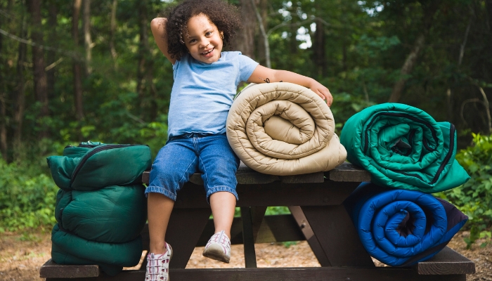 Kid surrounded by sleeping bags