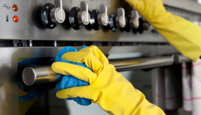 Closeup of hand cleaning the range