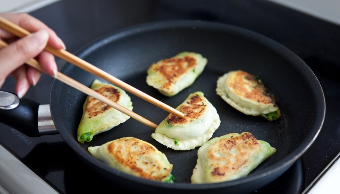 Closeup of food being cooked with almost no oil