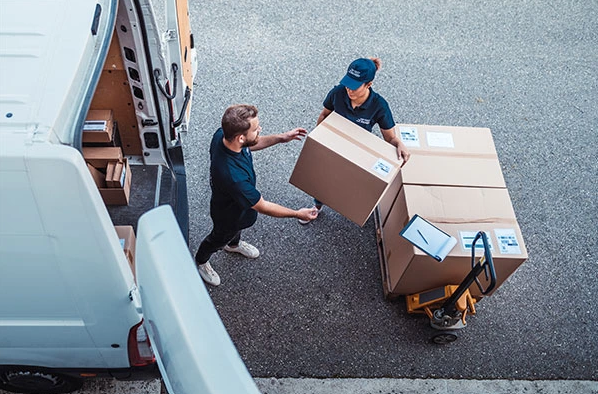 Two people delivering appliances
