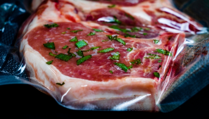 Close up of pork chops in a plastic sous vide bag