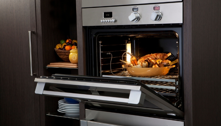  A closeup of a roast in the oven with a temperature probe in it