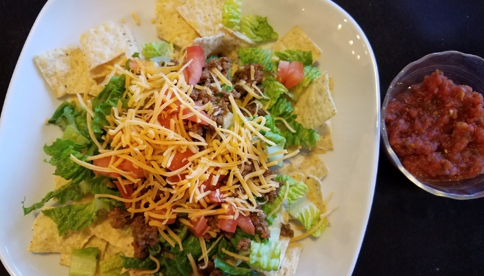 Closeup of a taco salad with tortilla chips and salsa
