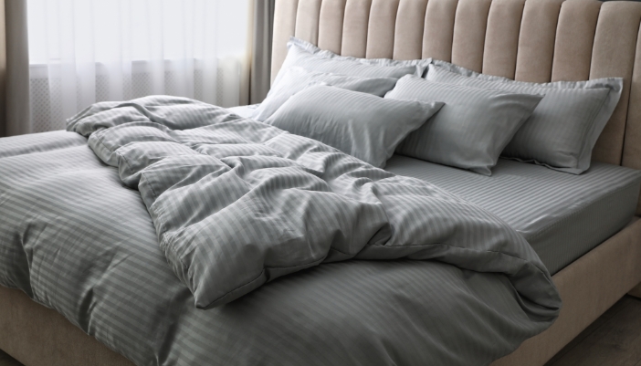 A big cotton comforter laid out on a mattress