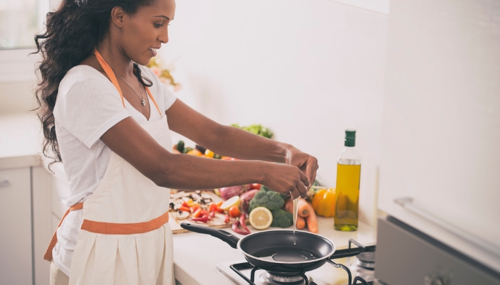 Closeup of someone frying eggs on a pan