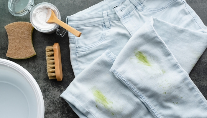 Closeup of stained pants next to a baking soda solution