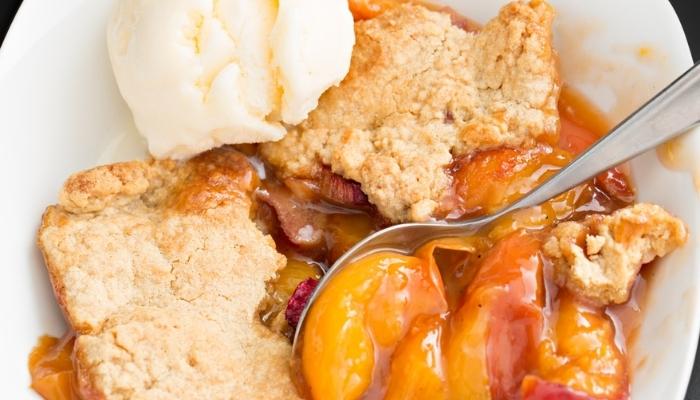 peach cobbler with a scoop of ice cream