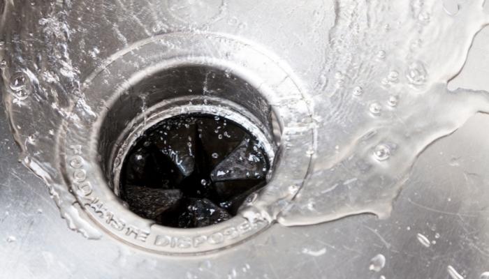 Water running down garbage disposal