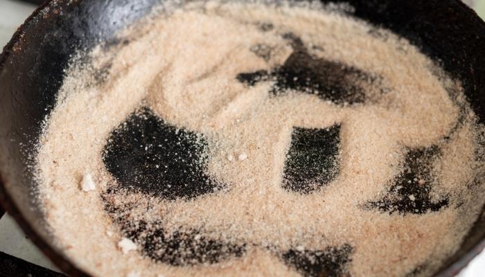 cast iron skillet with salt on the stove