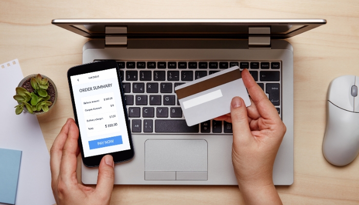 Closeup of someone paying for something online with a credit card; budget concept
