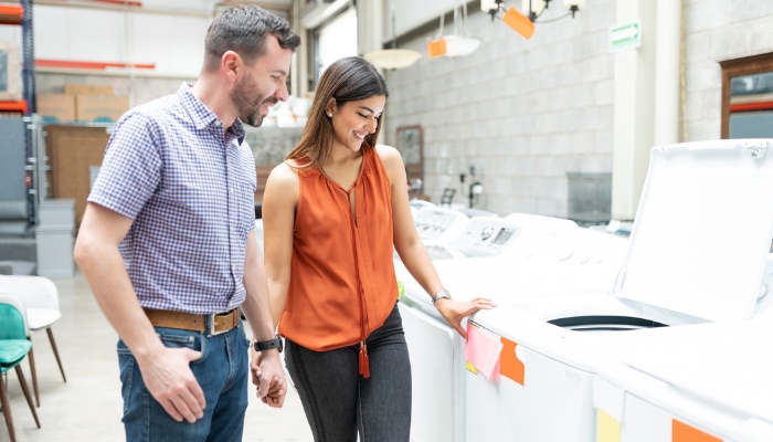 Couple shopping for a new washing machine