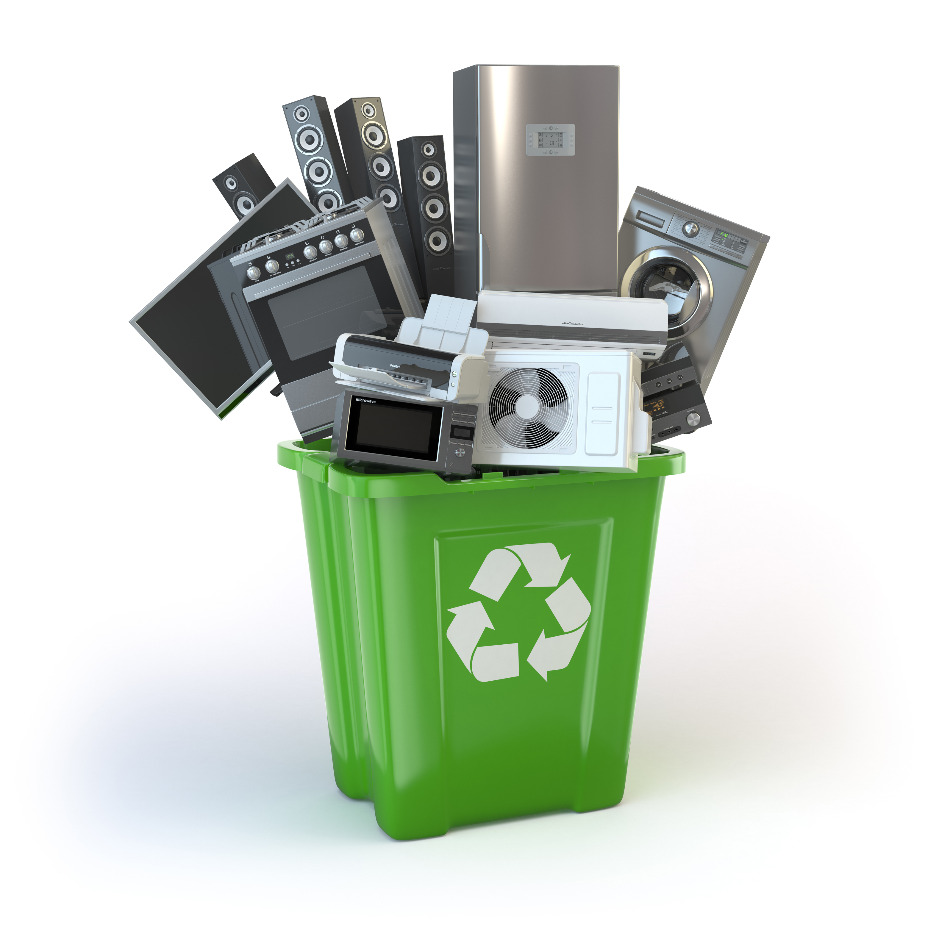 various household appliances sitting stacked in a green recycling bin