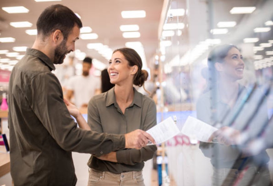man and woman buying appliance at store