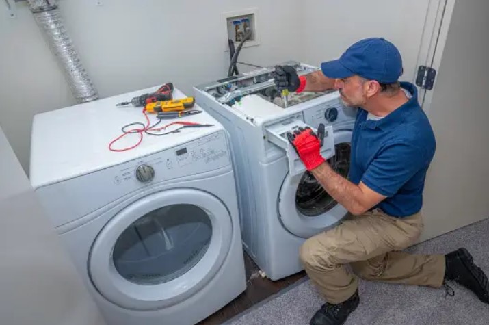 repair man fixing broken washer 