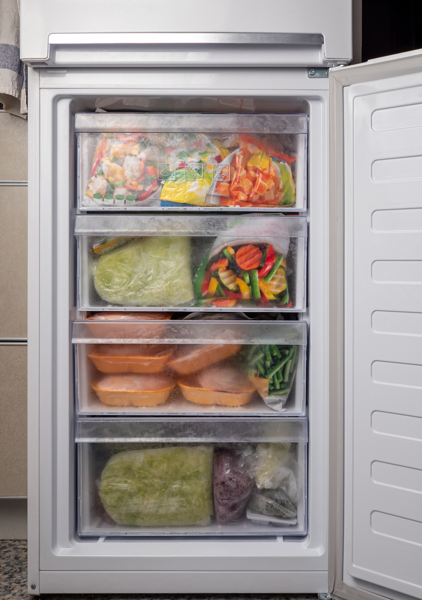 An upright freezer with several drawers for storage