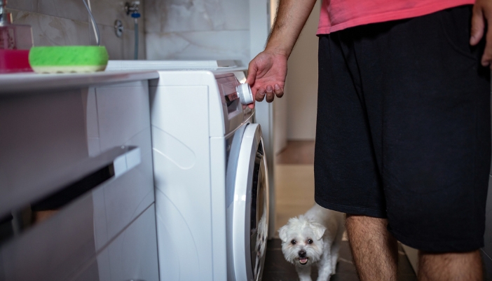 Closeup of someone customizing their washer settings to remove pet hair