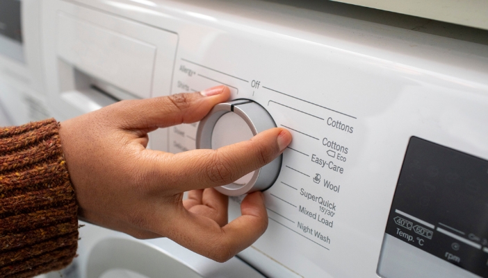 Closeup of a washer machine controls with the allergy+ cycle