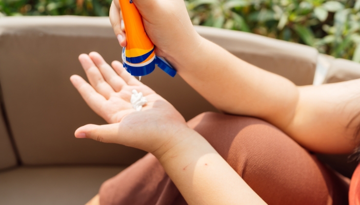 Closeup of someone applying sunscreen