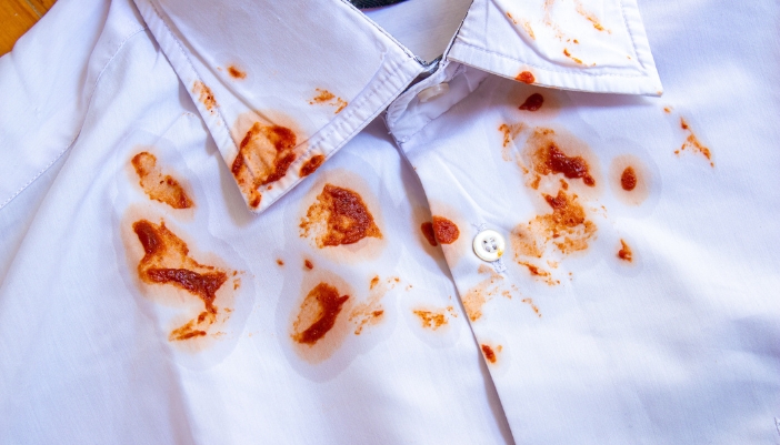 Closeup of a white shirt with BBQ sauce stains