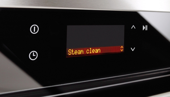 An oven display shows the words “steam clean.”