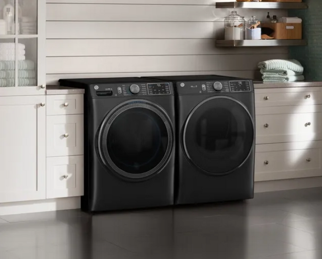 view of a dark grey ge laundry pair in a modern white laundry room