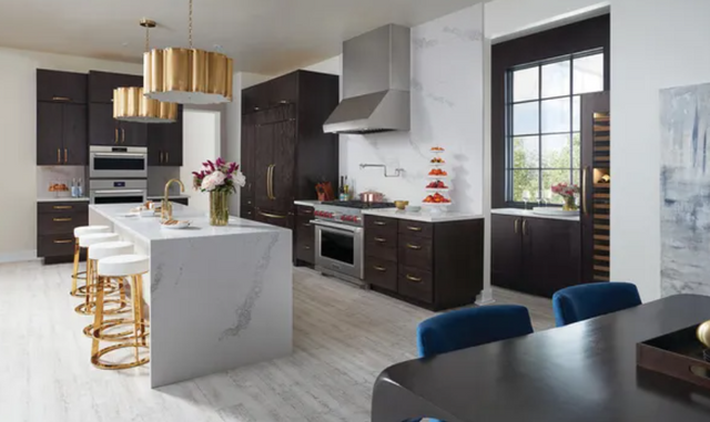 view of a modern kitchen with dark cabinets and a panel ready refrigerator 