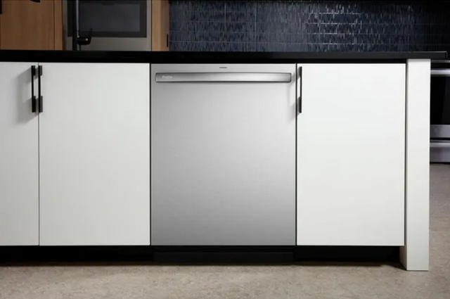 front view of a stainless steel dishwasher built into modern white cabinetry