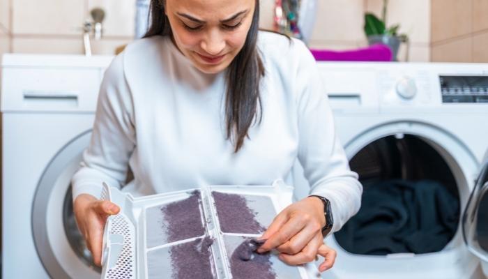 woman cleaning dryer filter