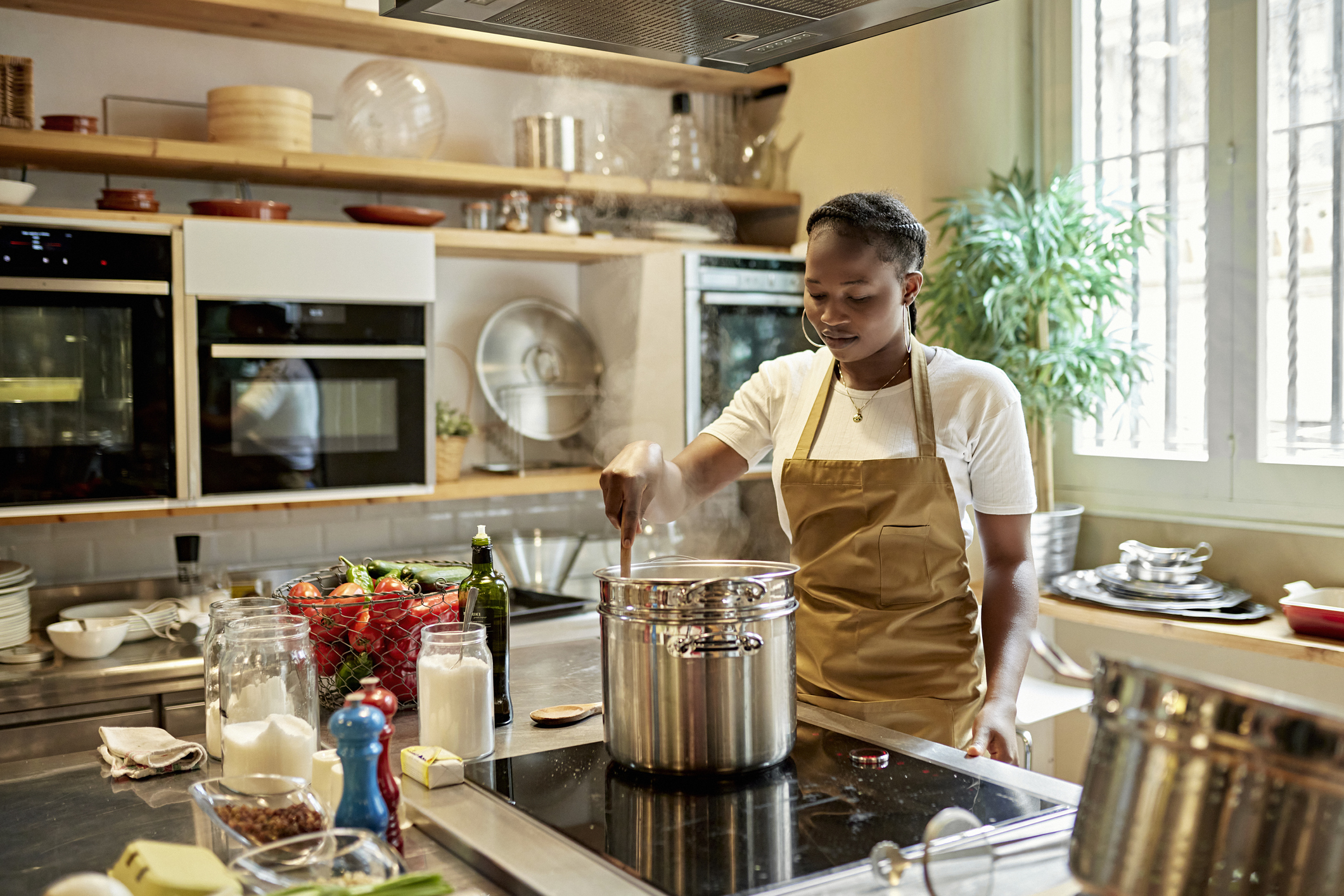 young woman cooking on induction range 
