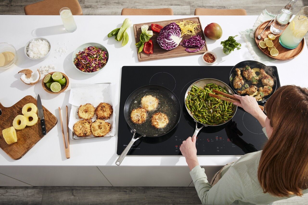 woman cooking on 36 inch cooktop 