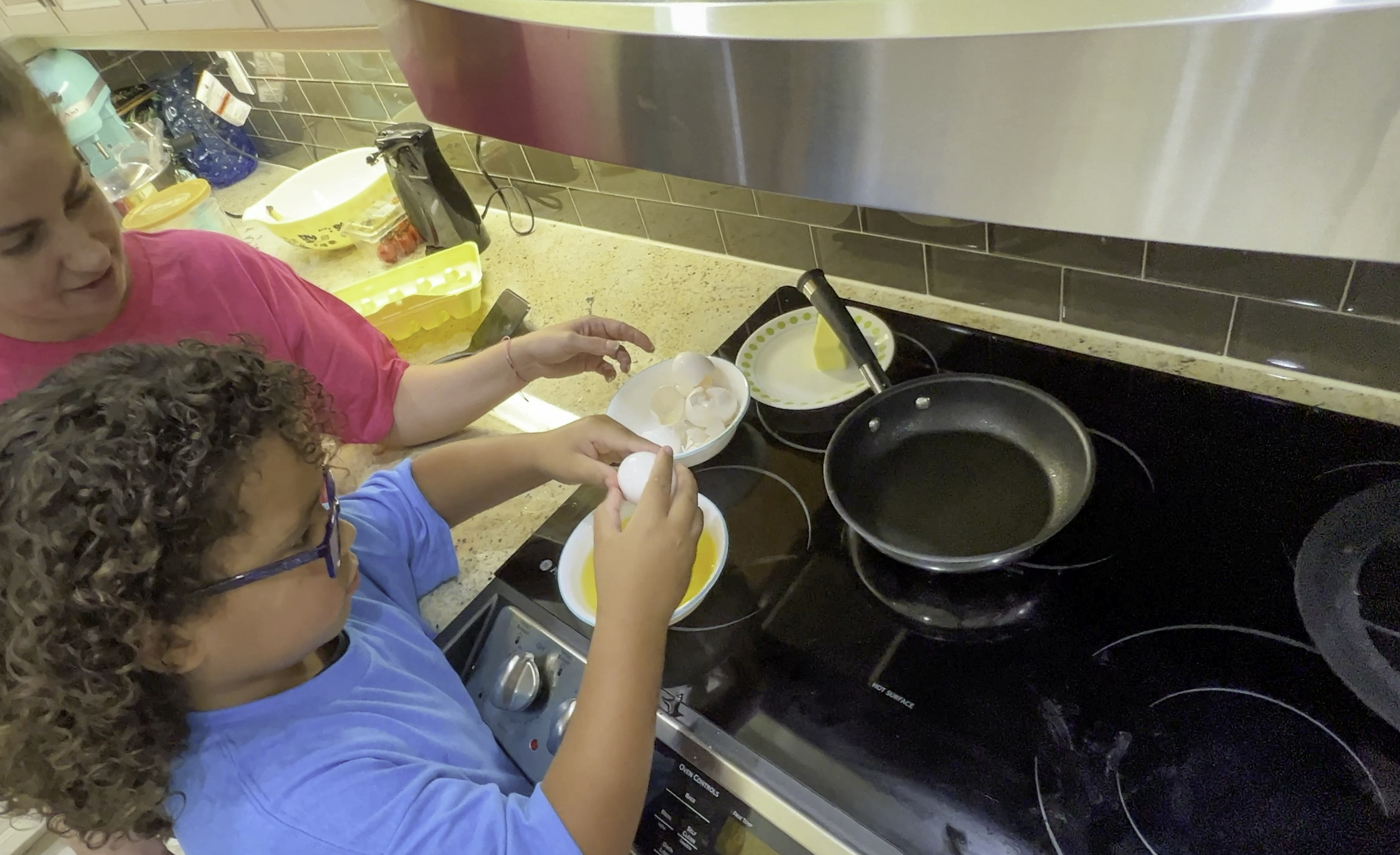parent and child cooking on range
