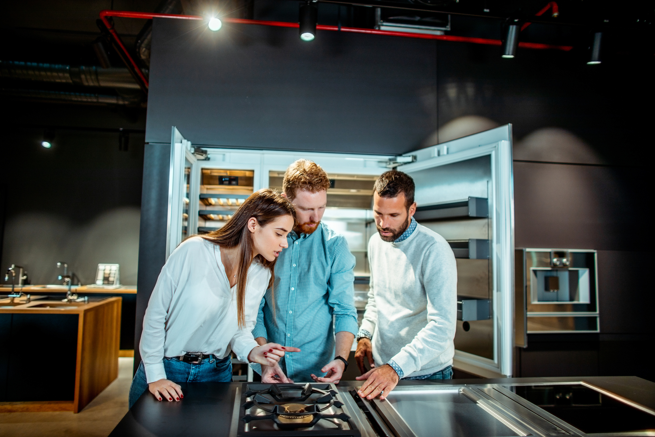 couple with salesperson in home appliance store