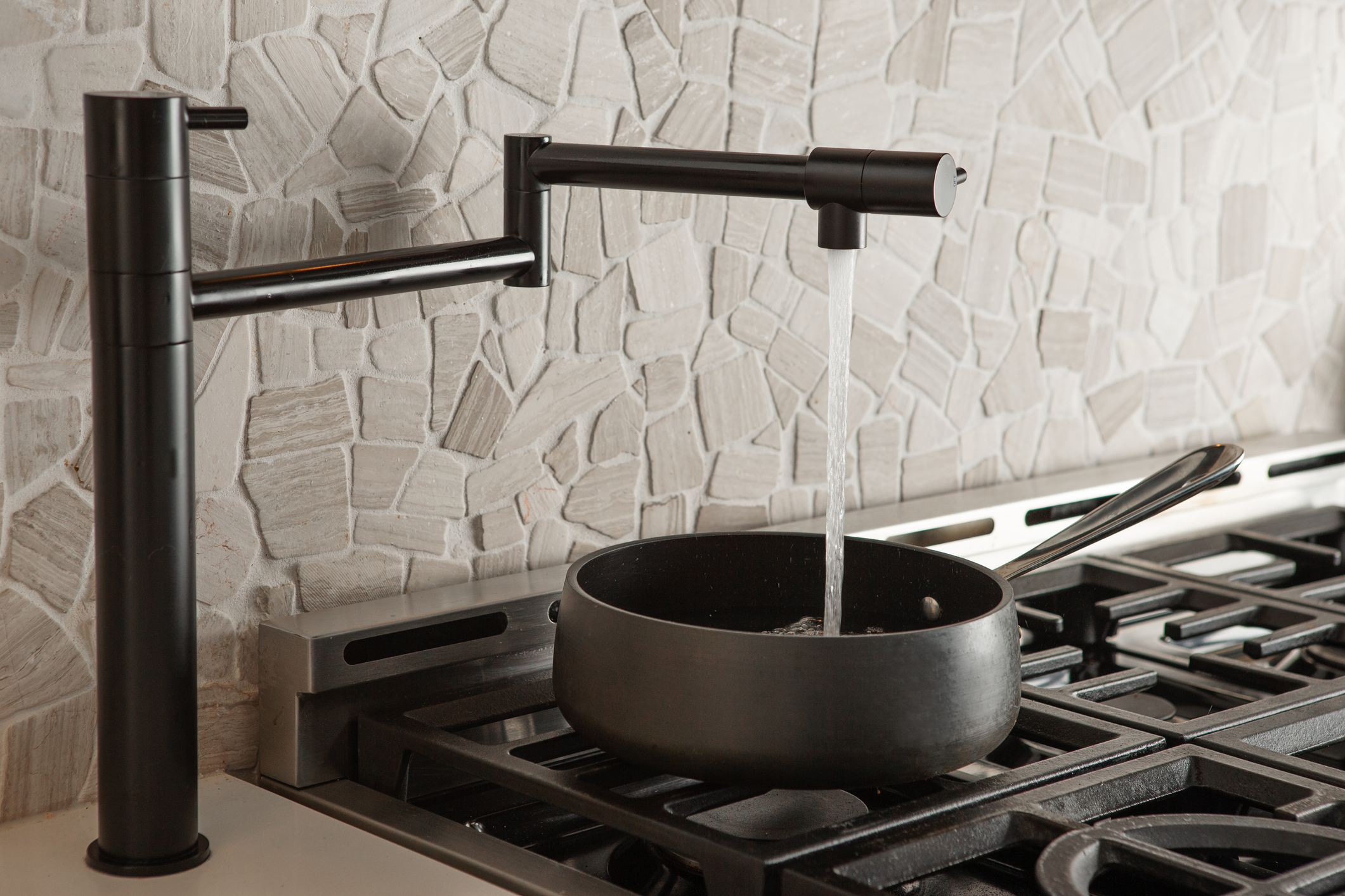 black finish pot filler over stove top