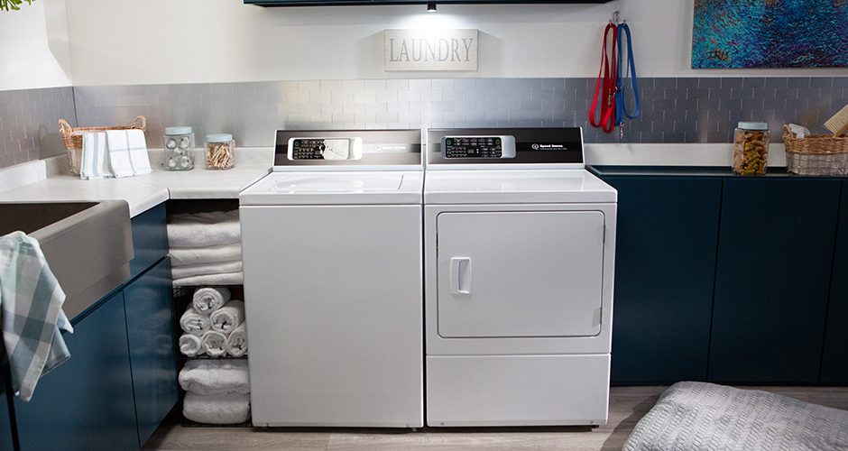 Speed Queen top load washer and dryer in a laundry room