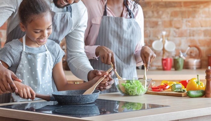 Closeup of someone using a non-stick ceramic-coated omelet pan to cook