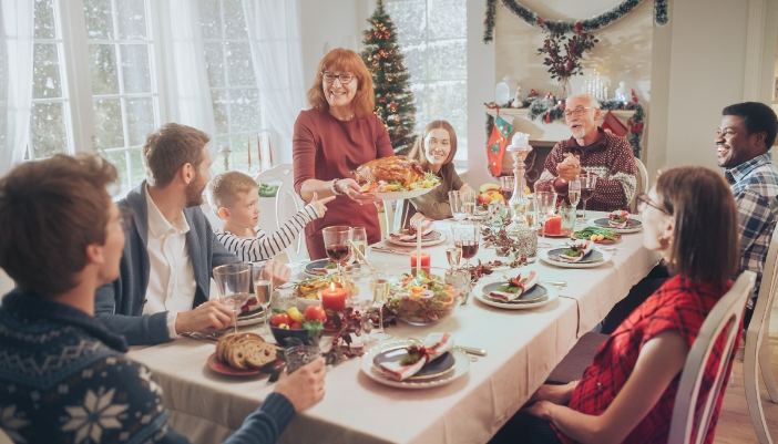 Family sitting down to Christmas dinner