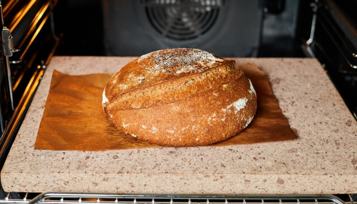 Closeup of bread baking on a baking stone