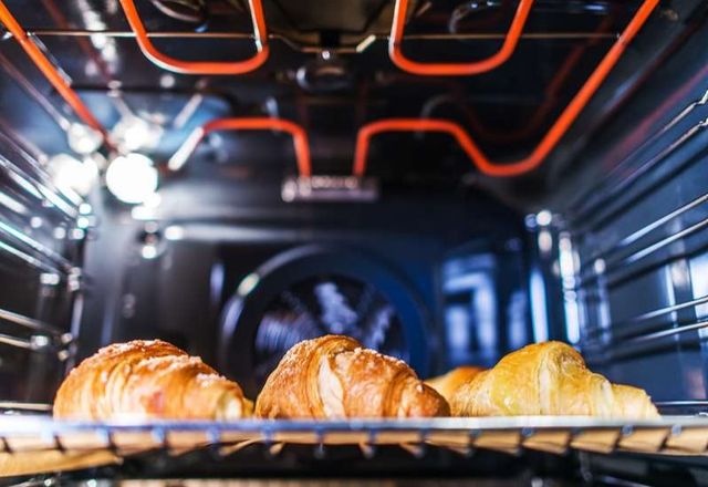croissants cooking in an oven
