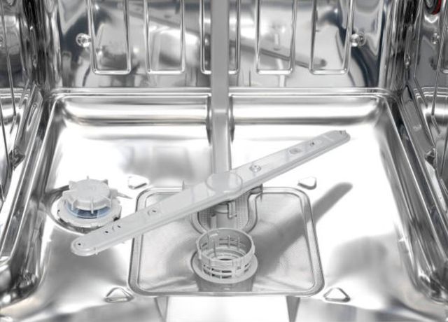 view of inside a dishwasher with racks removed to see motor at the bottom