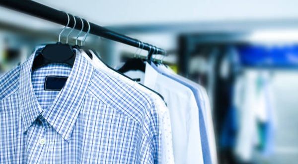 closeup of blue, white, black, and grey collared shirts on hangers