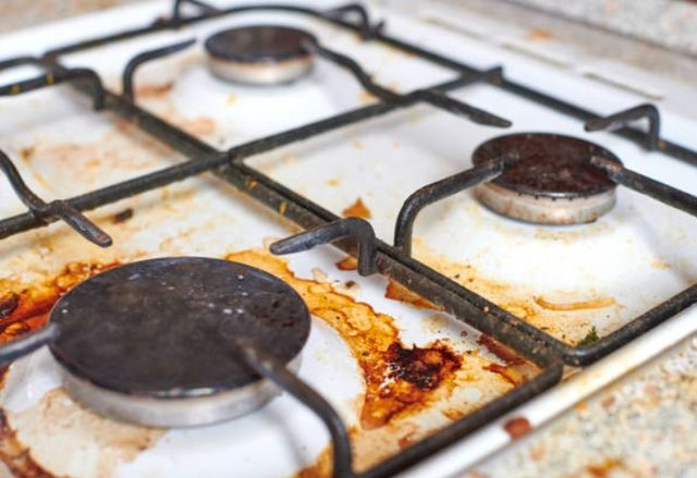 food burned onto a white gas stovetop