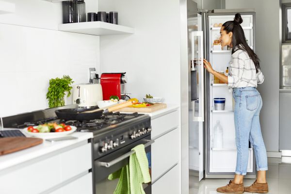 Woman Opening Up Refrigerator
