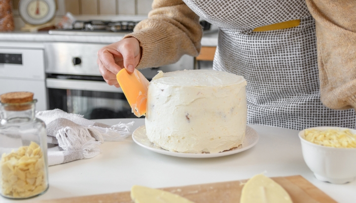 Closeup of someone frosting their cake